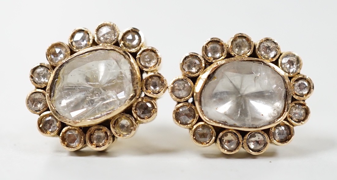 A pair of Indian yellow metal, flat and rose cut diamond set oval cluster earrings, 15mm by 13mm, gross weight 7.8 grams.